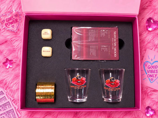 Match My Mood game box interior with shot glasses and dice on a pink fur background